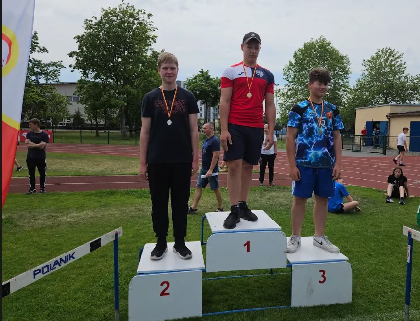 podium z udekorowanymi sportowcami